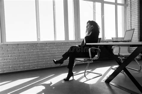 Portrait Of A Beautiful Successful Young Business Woman With Red Curly Hair In The Office