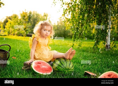 Portrait Of A Beautiful White Blonde Baby Girl With Watermelons In