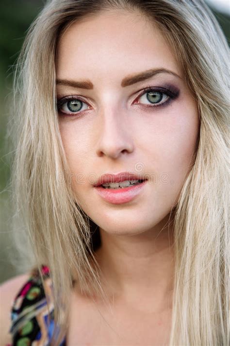 Beautiful Dreamy Blonde Girl With Blue Eyes In A Light