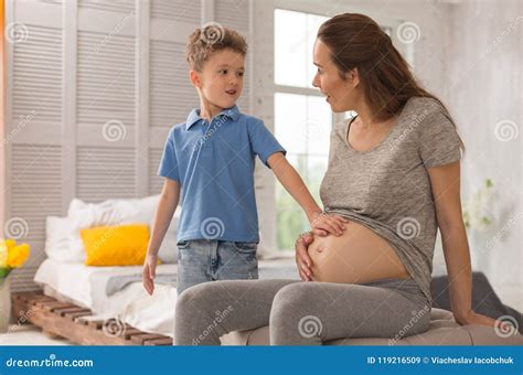 Sweet Adorable Son Touching His Expecting Mother Tummy Stock Image