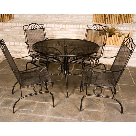 Despite the fact that it's heavy and hard, wrought iron patio furniture can be quite comfortable through the use of pillows. Napa Wrought Iron Patio Set by Meadowcraft