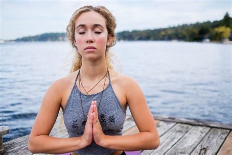 Beautiful Young Woman Practicing Yoga Near A Lake Del Colaborador De