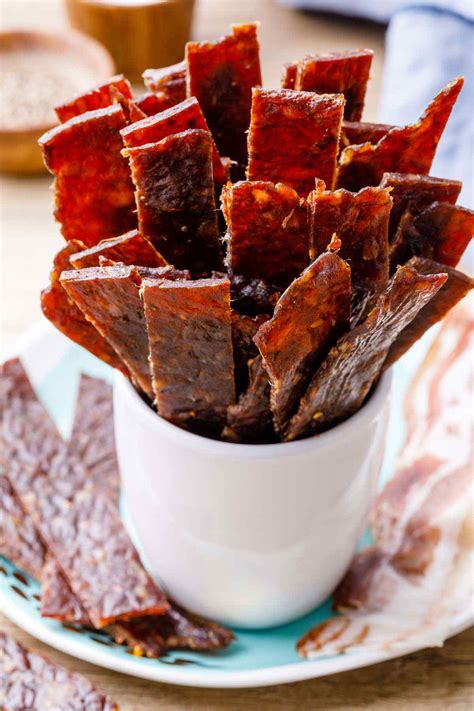 If you want to do ground meat jerky, but don't have a jerky gun, just roll seasoned meat mixture onto a piece of parchment or waxed paper, top with another piece of parchment and roll. Bacon Burger Jerky - Homemade Ground Beef Jerky Recipe - Healthy Substitute