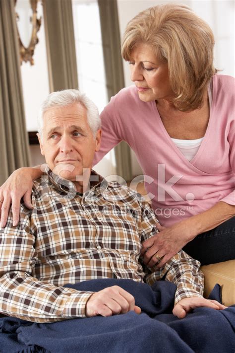 Senior Woman Caring For Sick Husband Stock Photos