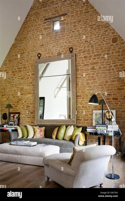 Exposed Brick Wall In Living Room With Pitched Ceiling And