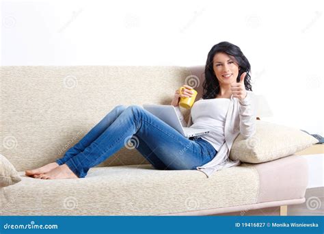 Beautiful Young Woman Relaxing On Sofa Royalty Free Stock Photography