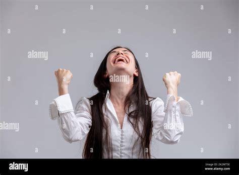 Jubilant Woman Laughing And Clenching Her Fists Stock Photo Alamy