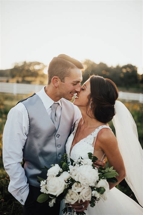 Sunset Bride And Groom Portraits In Field Of Wild Flowers By Meredith