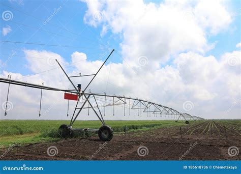 Modern Irrigation System In Field Under Sky Agricultural Equipment