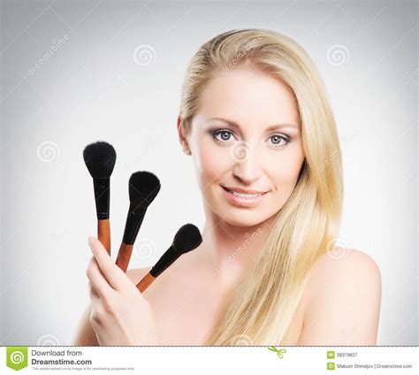 A Blond Woman Holding Makeup Brushes Stock Image Image Of Caucasian