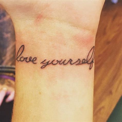 Wrist Tattoo Saying Love Yourself First On Michela