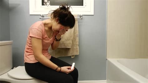 Teen Girl Cries From The Stress Of A Positive Pregnancy Test Stock