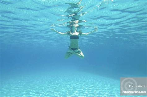 Underwater View Of Woman Swimming Stock Photo