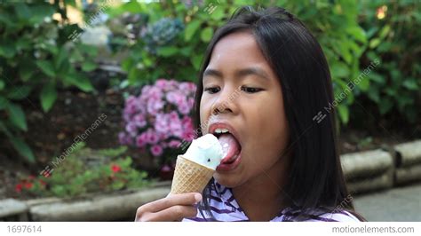 Young Asian Girl Eating Ice Cream Cone Stock Video Footage 1697614