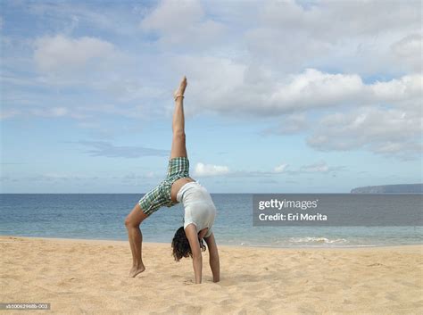 Teenage Girl Bending Backwards On Beach High Res Stock Photo Getty Images
