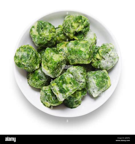 Frozen Spinach Blocks In White Bowl Shot From Above With Path Cut Out