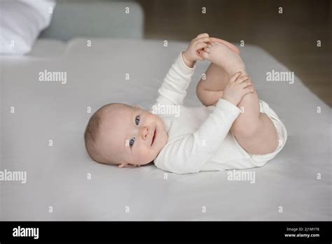 Portrait Of Happy Newborn Baby Lying On Bed Stock Photo Alamy