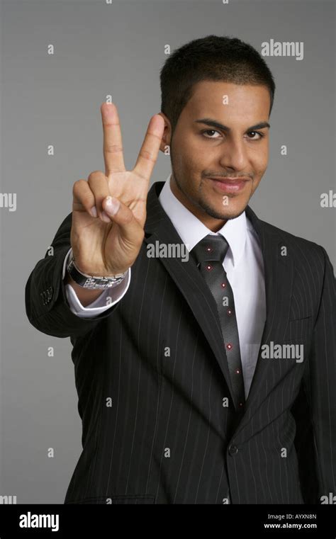 Businessman Making Peace Sign Stock Photo Alamy