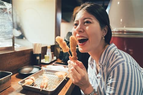 Premium Photo Young Girl Cheerfully Trying Japanese Dish Of Deep