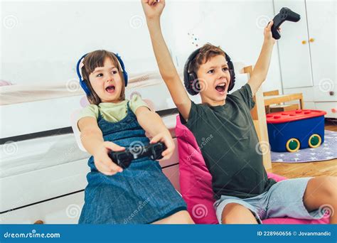Children Girl And Boy Playing A Video Game Stock Photo Image Of