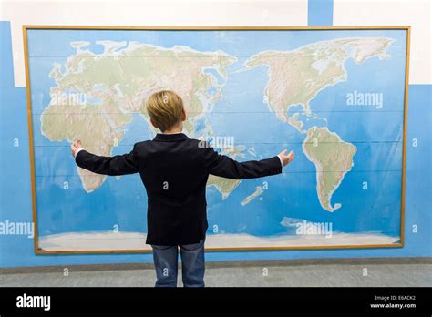 School Boy Standing In Front Of Blind World Map Hi Res Stock