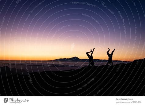 Silhouette Of Two Handstands With The Sunset A Royalty Free Stock