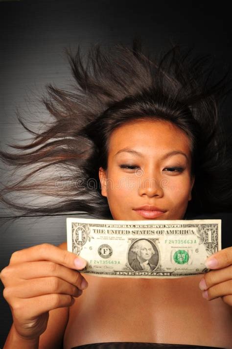 Chinese Asian Woman Looking At Dollar Bill Picture Image 7839408