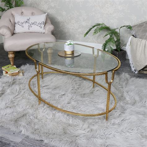 Do you want to worry about a spilled drink on a wood coffee table or a glass one? Large Gold Oval Glass Topped Coffee Table