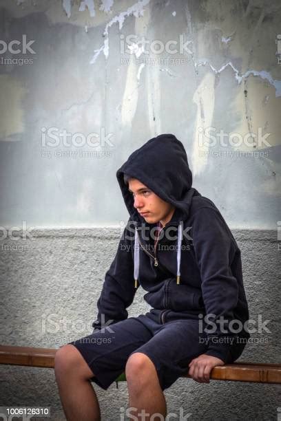 Little Boy Sad Sitting Alone At School Hides His Face Stock Photo