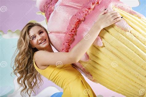 Beautiful Woman With Wavy Hair Blonde In Yellow Dress Holding A Giant