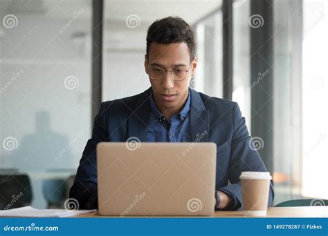 Concentrated African American Businessman Working At Laptop In Office