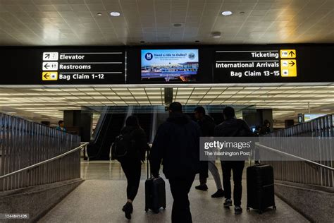 Travelers Pass A Sign For The New Metro Station At Dulles News Photo