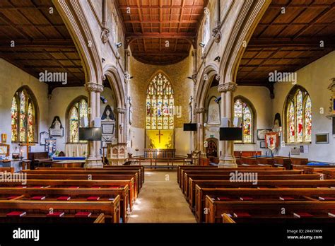 Interior view of nave, chancel, apse, altar, stained glass windows and