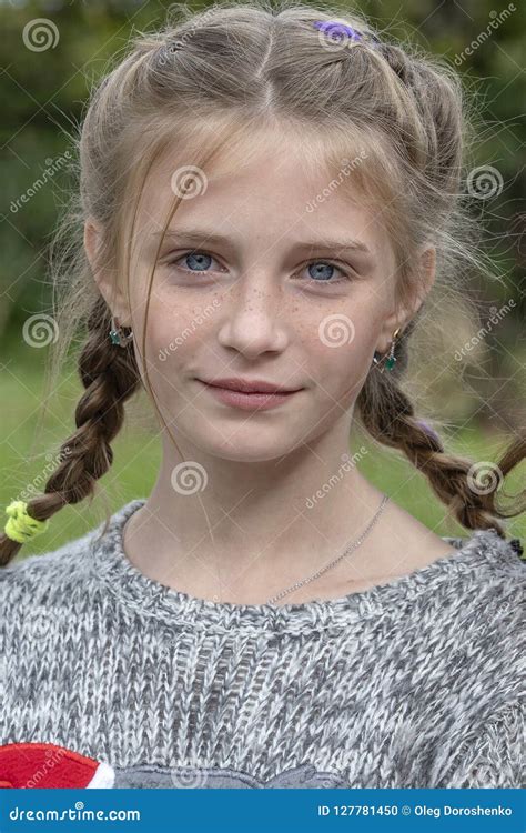 Beautiful Blond Young Girl With Freckles Outdoors On Nature Background