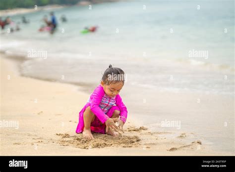 Little Asian Girl Playing On The Beachvacation And Relax Concept Stock