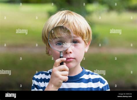 Curious Little Boy Looking Through Magnifying Glass Stock Photo Alamy