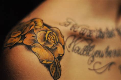 Many men and women prefer to have a tattoo on just shoulder cap. Men's yellow rose flower tattoo on shoulder