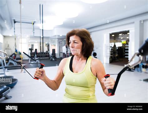 Senior Woman In Gym Working Out With Weights Stock Photo Alamy