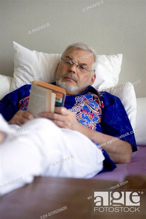Book Old Man Lying On A Bed Stock Photo Picture And Low Budget