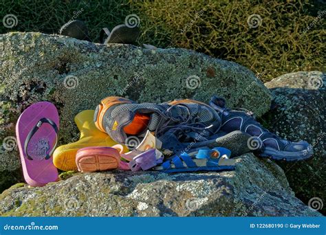 A Pile Of Abandoned Or Lost Shoes And Assorted Footwear Stock Photo