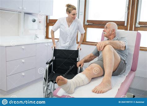 Nurse Helping Recovering Patient To Wheelchair Stock Image Image Of
