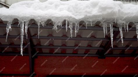 Premium Photo Winter Icicles Melting On The Roof Under The Spring Sun