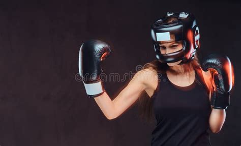 Portrait Of A Female Boxer Wearing Protective Helmet And Gloves During
