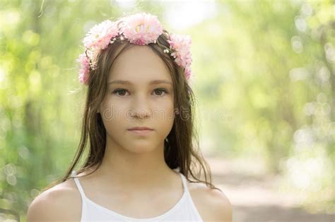 Beautiful Caucasian Preteen Girl Wearing Flower Wreath And White Dress