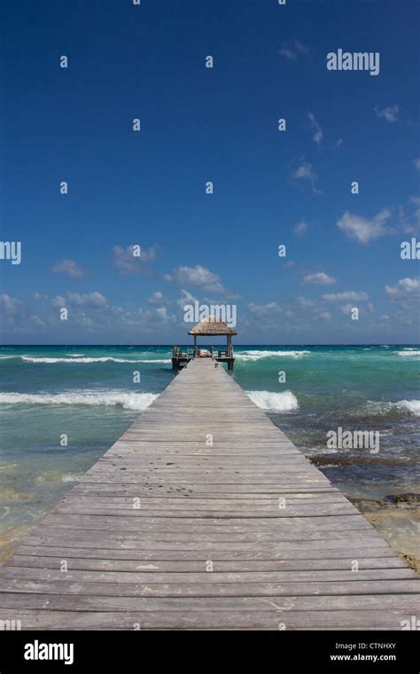 Wooden Jetty Leading Into The Perfect Turquoise Waters At A Natural