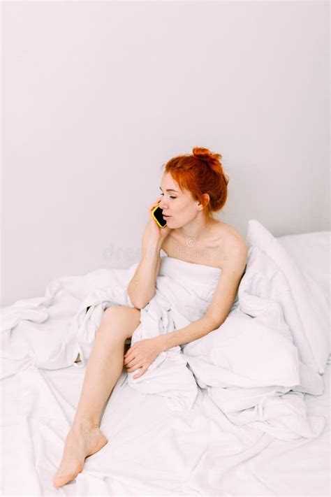 Portrait Of A Young Beautiful Redhead Woman Talking On The Phone In Bed Stock Image Image Of
