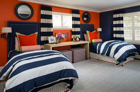 Modern primary bedroom with a modish black bed setup with an orange accent and is lighted by stylish wall lights. red and blue boys room kids transitional with round mirror ...