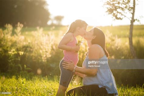 Young Pregnant Woman Kissing Her Adorable Loving Daughter Photo Getty