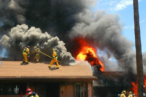 Upset and fired businessman standing near building and looking at carton box. TWO-ALARM FIRE DESTROYS HOME ON GROSSMONT AVE.; OCCUPANTS ...