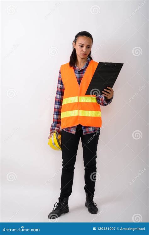 Full Body Shot Of Young Asian Woman Construction Worker Standing Stock